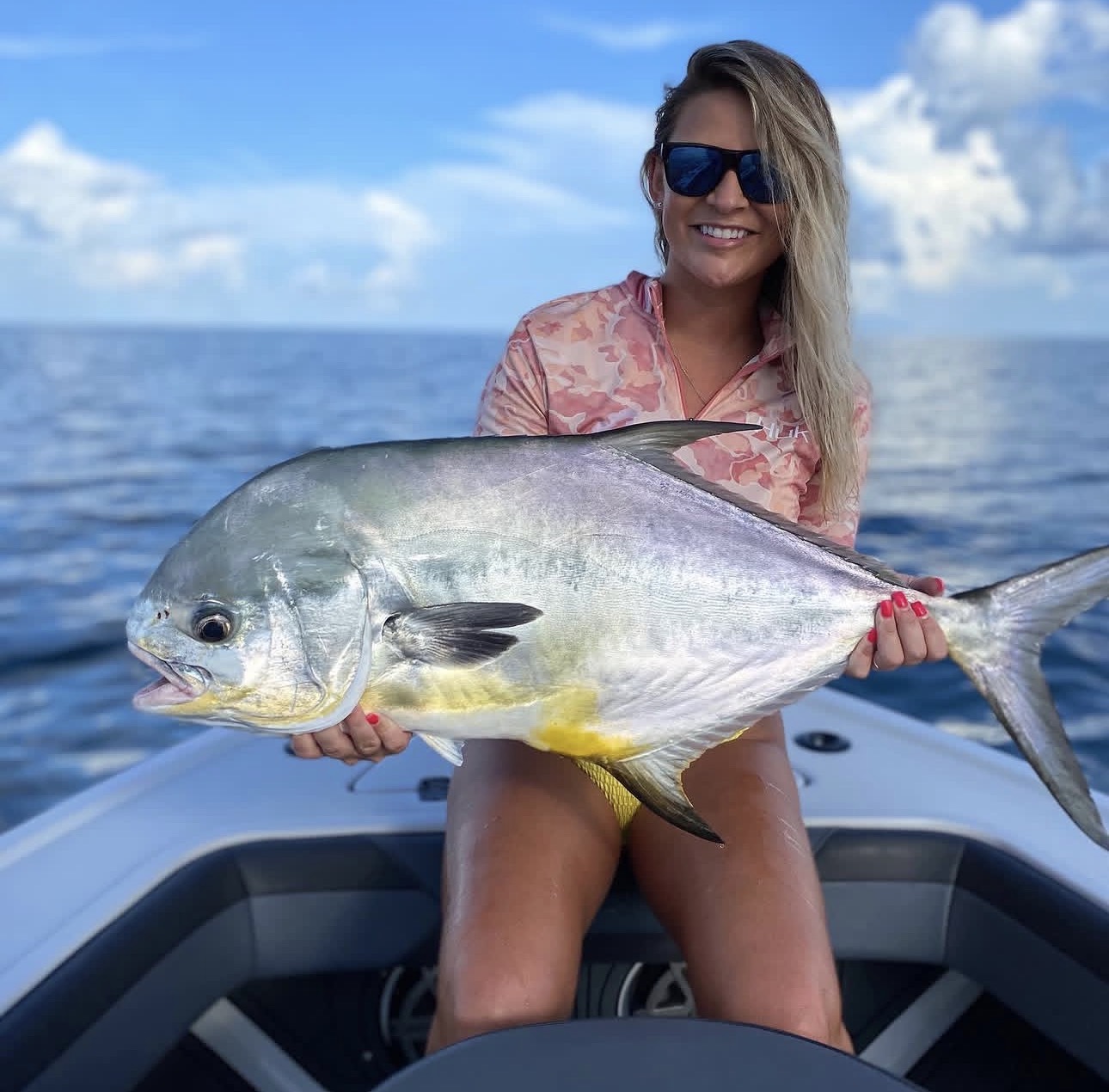 Angler holding a permit on the bow
